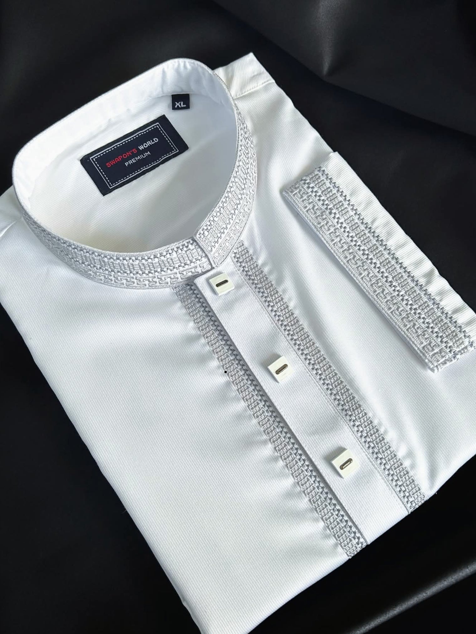 White shirt with decorative details on a black background
